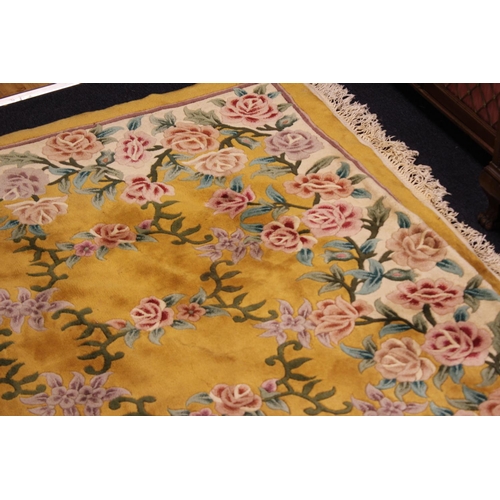 267 - A Large Chinese yellow ground floral and ribbon woven shaped and fringed carpet. Measuring: 274cms x... 