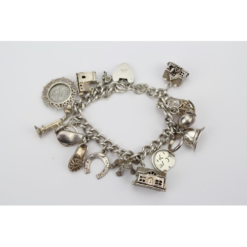 146 - A Silver Charm Bracelet to include a House, Helmet, Church, Horse Shoe, Rocking Chair, etc. Total We... 