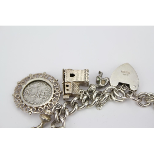 146 - A Silver Charm Bracelet to include a House, Helmet, Church, Horse Shoe, Rocking Chair, etc. Total We... 