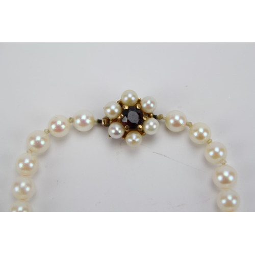 65 - A 9ct Gold clasp mounted string of knotted pearls.