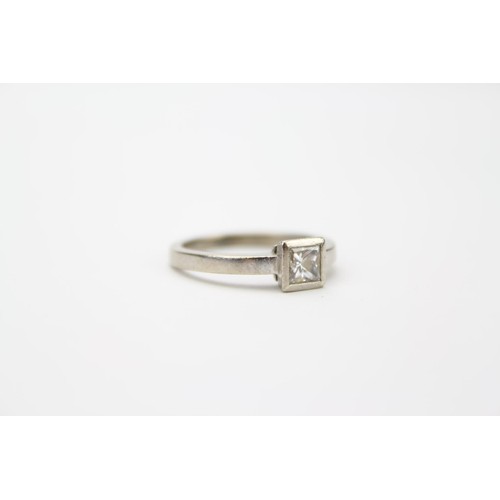 93 - A Ladies 18ct White Gold Dress Ring Mounted with a Square Cut Diamond in a Roll Over Setting. Size: ... 