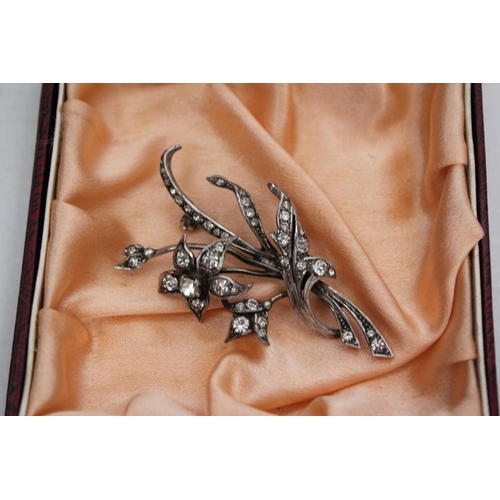 100 - A French Silver coloured white metal floral brooch mounted with paste in Case.