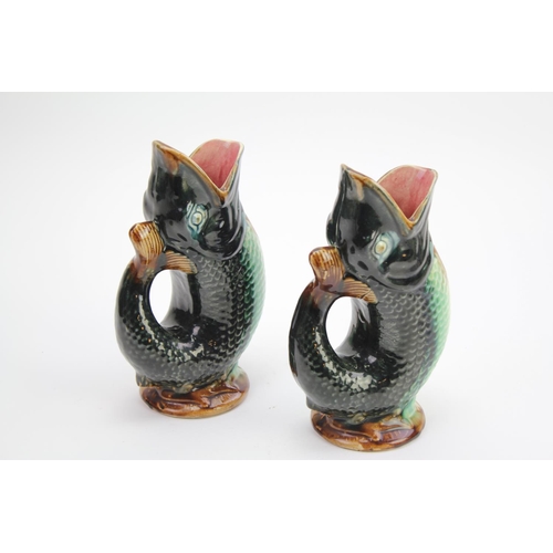 460 - A pair of Belgium pottery jugs designed as fish.