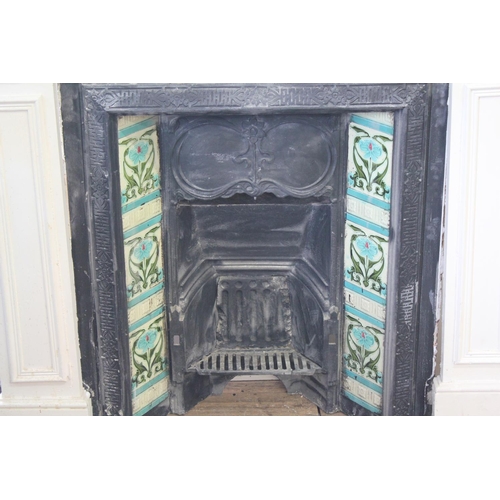 535 - A Late 19th Century tile mounted fire place with surround. Measuring: 91 cms x 80 cms. (Fire place).