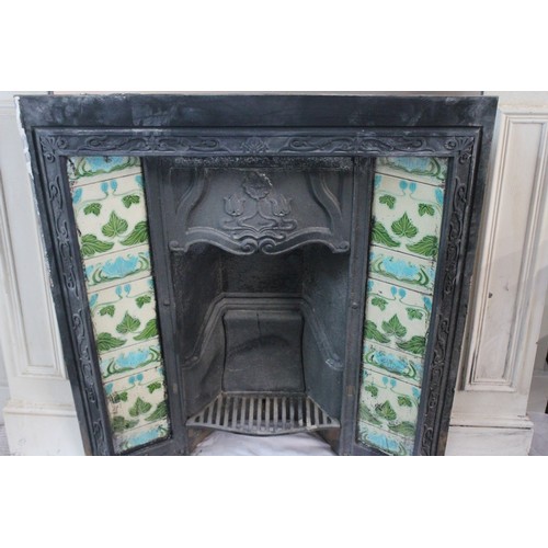 536 - A Late 19th Century tile mounted fire place with surround. Measuring: 91 cms x 80 cms. (Fire place).