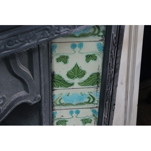 536 - A Late 19th Century tile mounted fire place with surround. Measuring: 91 cms x 80 cms. (Fire place).