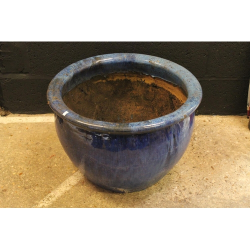 552 - A Large blue glazed terracotta garden pot. Measuring: 62 cms x 41 cms.