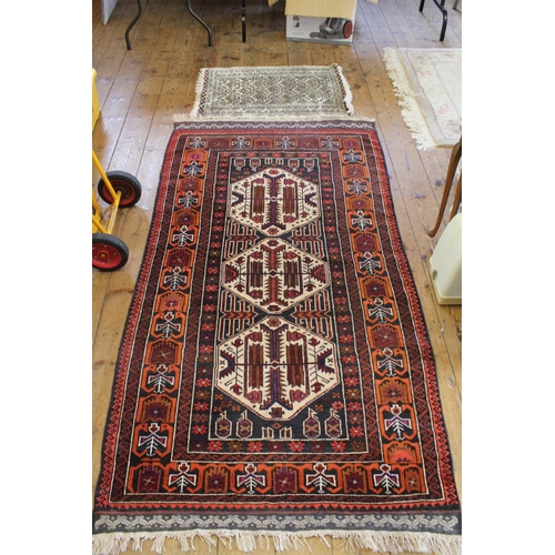 285 - A Red and Blue Geometric Shaped Rug with fringed edge. Measuring: 215 cm x 115 cm.