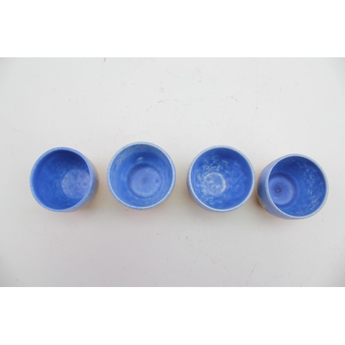 486 - A Ruskin of West Smethwick Blue and Orange Glazed 4 piece Egg Cup set with matching dish.