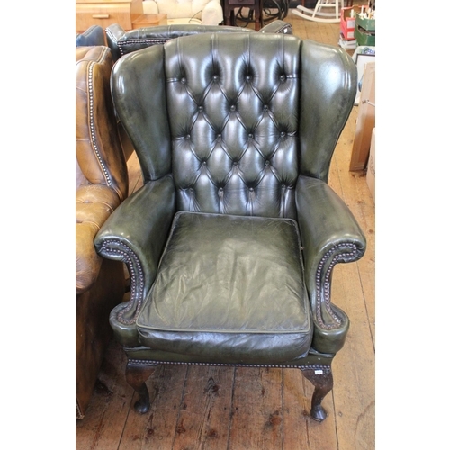 367 - A Green Leather Button Back Easy Chair on shaped legs.