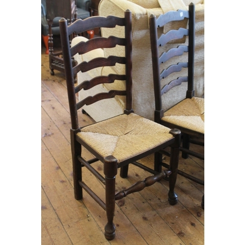 372 - A set of 4 Lancashire Splat and Rush seated chairs on turned legs.