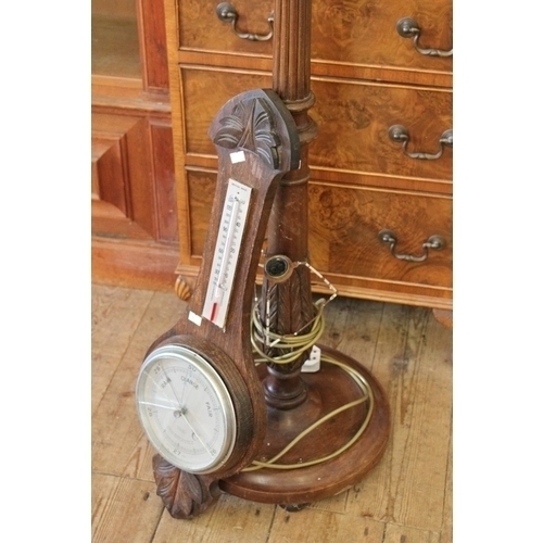 373 - An Oak Case Banjo Barometer and a turned wood standard lamp.