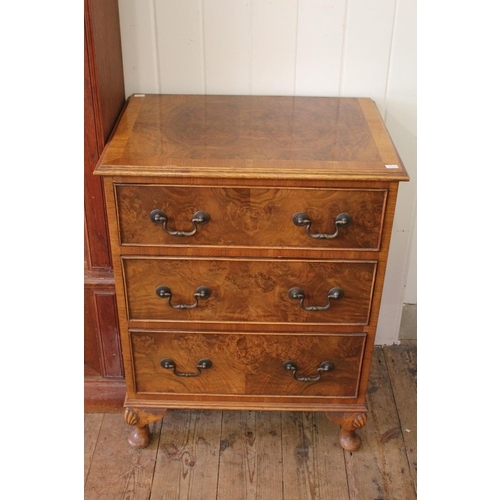 374 - A reproduction cross banded walnut chest of three drawers. Measuring: 55 cms wide x 38 cms deep x 72... 