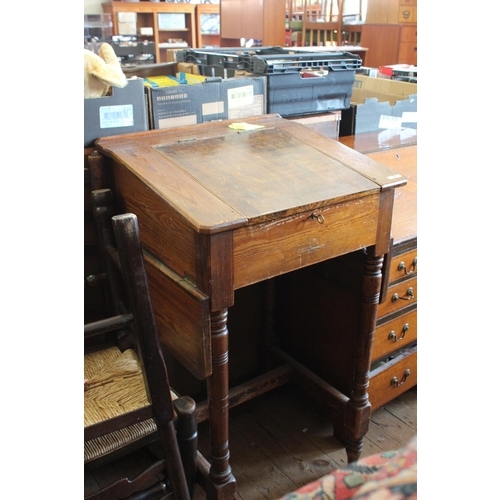 375 - A Early Eton standing pitch pine school desk with side shelf. Measuring: 60 cms wide x 55 cms deep x... 