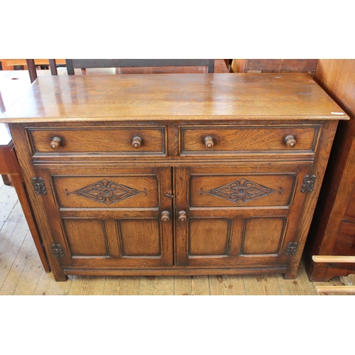 379 - An Oak Sideboard with fitted 2 x drawers and cupboards below. Measuring: 120 cms wide x 44 cms deep ... 