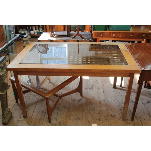 381 - A Glass Topped Dining Table standing on shaped legs. Measuring 89 cms wide x 130 cms long.