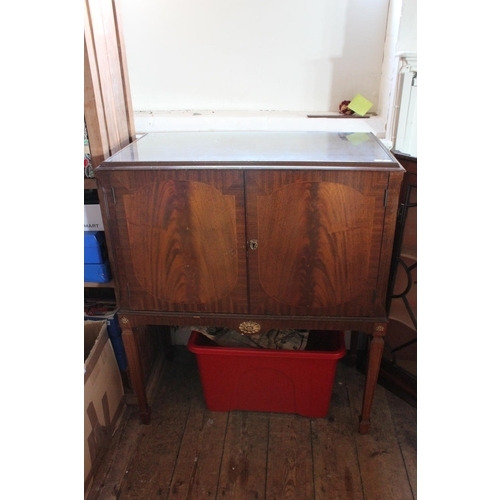 386 - A Reproduction Mahogany Cross Banded Cocktail Cabinet resting on Square Adams Legs with a Glass Top.... 