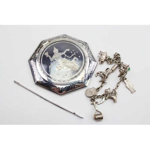 80 - A Ladies Silver Charm Bracelet and a Siam Niello Powder Compact.