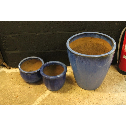 597 - Three Terracotta blue glazed garden pots, one large, Measuring: 41 cms x 49 cms. along with two smal... 