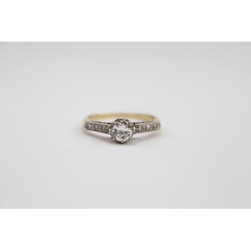 285 - A ladies Platinum and 18 carat Gold mounted Diamond ring, with chip shoulders. Size approx L. Diamon... 