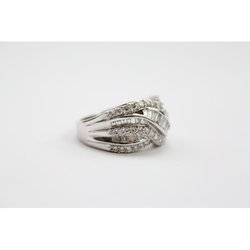 215 - A ladies 18 carat white Gold diamond ring, mounted with baguette & round diamonds. Size N. Weight ap... 