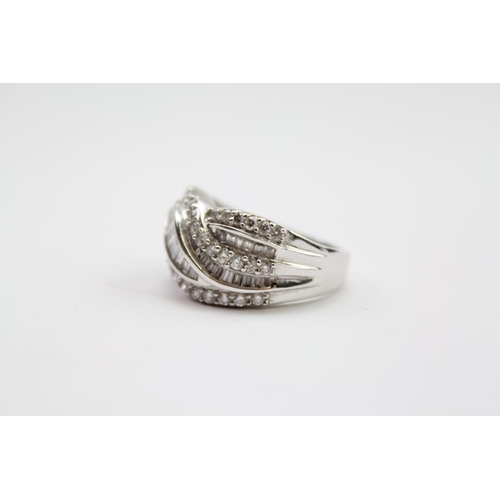 215 - A ladies 18 carat white Gold diamond ring, mounted with baguette & round diamonds. Size N. Weight ap... 