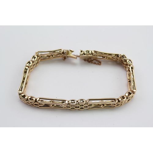 278 - A Victorian design curb and oval link bracelet, with safety chain, marked 9 ct. Weighing approximate... 