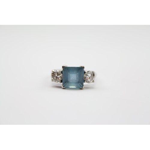 219 - A ladies platinum mounted aquamarine ring, mounted with two diamonds on shoulders. Size L. Diamonds ... 