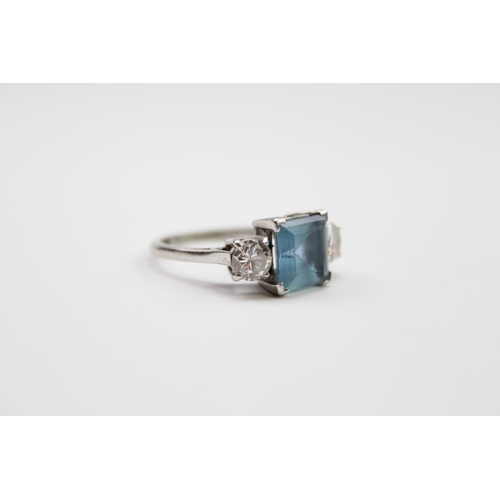 219 - A ladies platinum mounted aquamarine ring, mounted with two diamonds on shoulders. Size L. Diamonds ... 