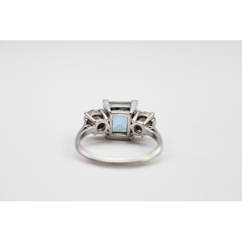 219 - A ladies platinum mounted aquamarine ring, mounted with two diamonds on shoulders. Size L. Diamonds ... 