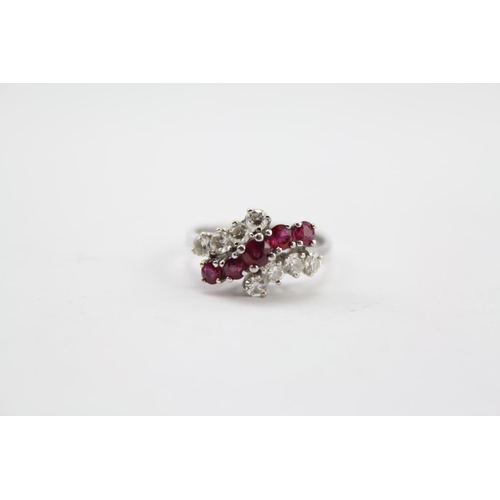 207 - A 14ct Gold diamond and ruby set ring, in a cross over setting. Set with 8 Diamonds and five Rubies.... 