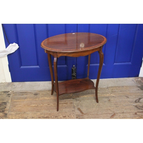 415 - An Edwardian Satinwood inlaid Oval Tea Table resting on shaped legs. Measuring: 63 cms wide x 41 cms... 