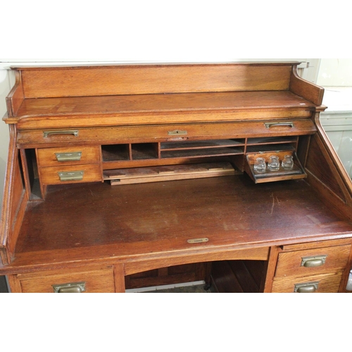 427 - An American Design Tambour Topped Roll over desk fitted with pedestal sides and glass inkwells. Meas... 