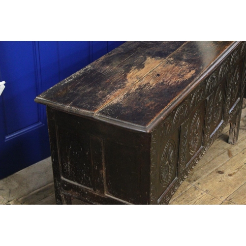 428 - An Antique Oak Coffer with carved panels and resting on elongated legs. Measuring: 121 cms across x ... 