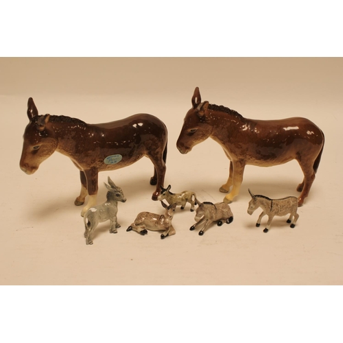 539 - A pair of Beswick donkeys along with miniature donkeys.