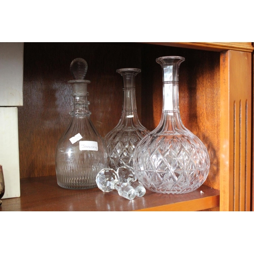 355 - Two thumb cut sherry decanters along with an Irish decanter.