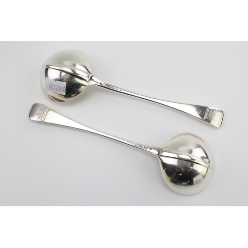 32 - A Pair of Silver Old English Rat Tail sauce ladles by George Adams, London E, with family crest.