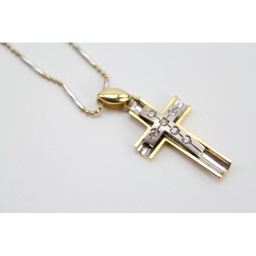 156 - A Ladies 750 marked Gold Cross mounted on an Italian White & Yellow Gold Chain. Weighing: 6.9 grams.