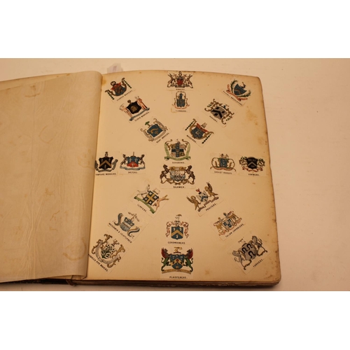 318 - An interesting leather bound book containing letter headings, company crests, family heraldic crests... 