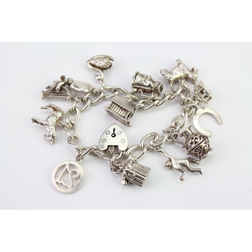 168G - A Silver Charm Bracelet hung with various charms. Weighing: 60 grams.