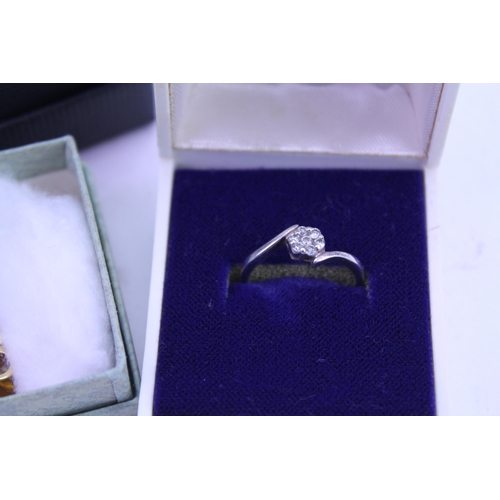 151 - A Diamond Cluster Silver Set Dress Ring along with three small boxes of costume jewellery.