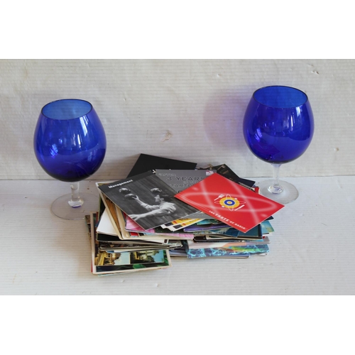 883 - A collection of modern postcards and two blue glasses.