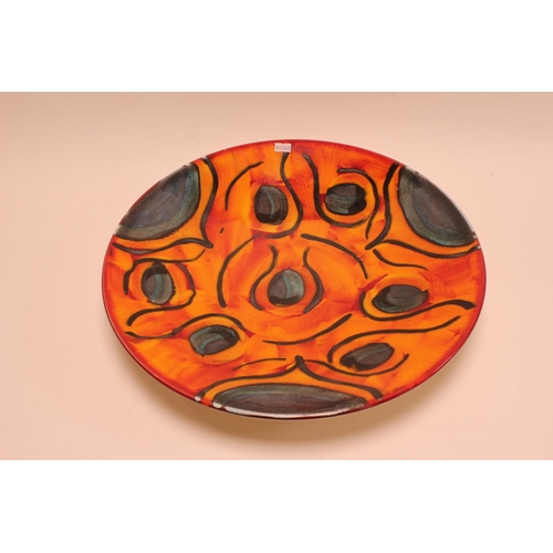 877 - A Large Poole Pottery Decorative Plate in Orange & Green. Measuring: 41.5cms across.