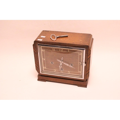 217 - Art Deco square oak cased clock, with white painted chapter ring, chrome door, and 3 key holes.