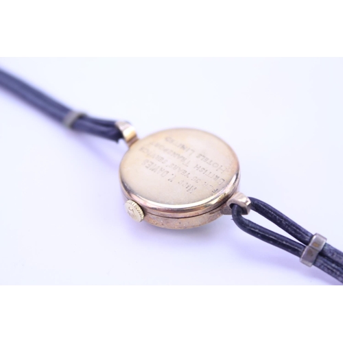 188 - An Early Ladies Gold TUDOR Wristwatch on a Black Leather Strap.