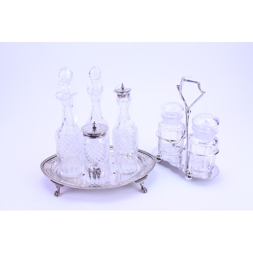 79 - A Silver plated condiment bottles on a Silver plated stand along with a plated pickle set.