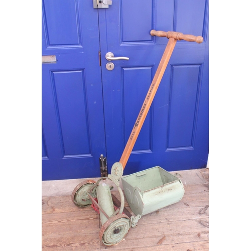 556 - An Original 1920s Ransom push along lawn mower finished in Light Green along with a bed warmer.