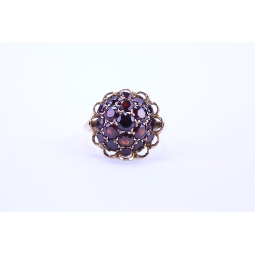 105 - A 9ct Gold dress ring mounted with garnets. Size approx Q.