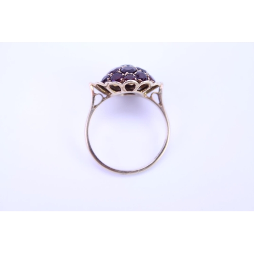 105 - A 9ct Gold dress ring mounted with garnets. Size approx Q.