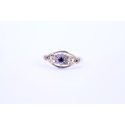 106 - A 9ct Gold dress ring set with a single Sapphire, surround set with paste. Size approx Q.